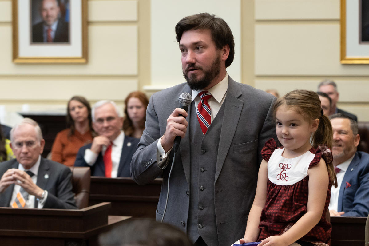 Sen. John Michael Montgomery is joined by his daughter, Elizabeth, as he introduces his family after a swearing-in ceremony at the state Capitol. 