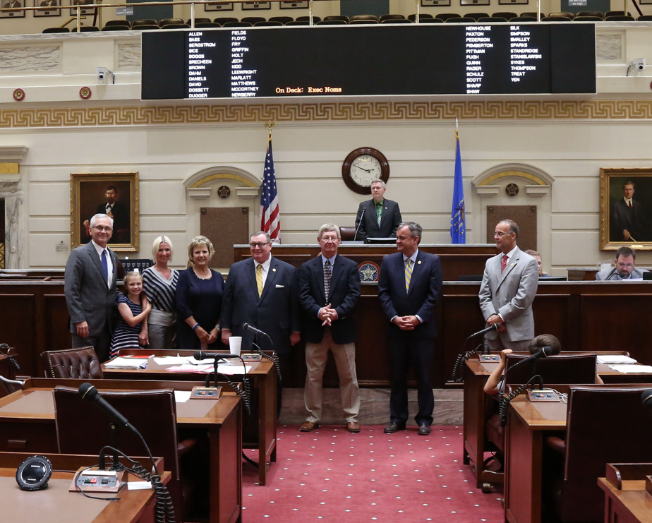 Sen. Darcy Jech, R- Kingfisher (far left) joins SEOSU Coach Mike Metheny (center), SEOSU President, Sean Burrage (2nd from right), SEOSU Athletic Director Keith Baxter (far right) and former SEOSU president and Chancellor of Higher Education Glen D. Johnson (left of Coach Metheny) on the Senate floor at the State Capitol on Tuesday, May 9.   Also pictured are Metheny’s wife Pat, daughter Mishael and granddaughter Raini.