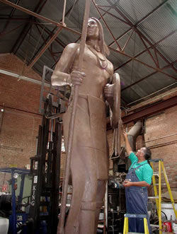 Senator Kelly Haney adds final touches to his sculpture "The Guardian".