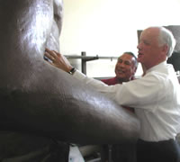Senator Haney watches as Governor Keating works on the Guardian Statue.