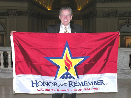 Sen. Bill Brown displays the Honor and Remember Flag given to his family in honor of his father who was killed in World War II.