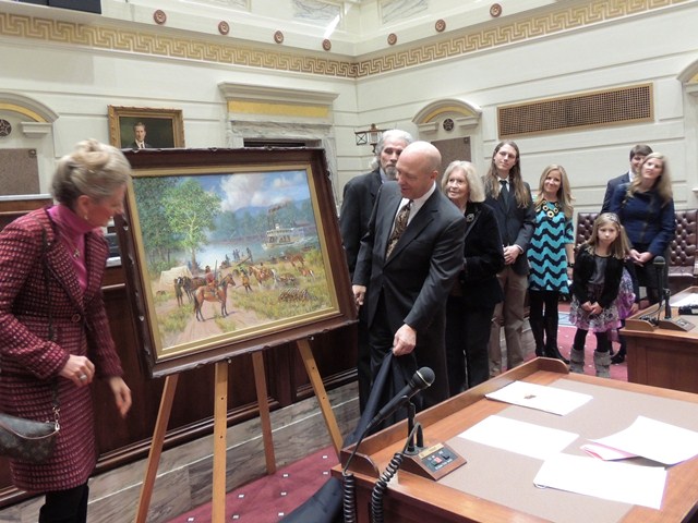 Marnie and Clayton Taylor unveil the painting by artist Wayne Cooper.