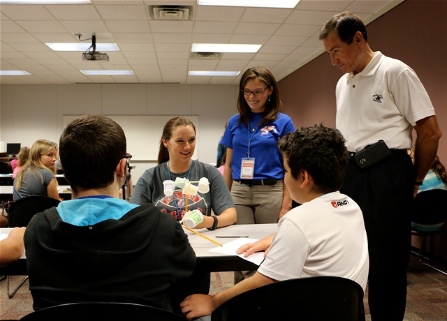 Sen. Ron Sharp and Gordon Cooper Career Technology Center (GCTC) STEM program coordinator, Dr. Andrea Ellis, listen to teacher Megan Wilder as she discusses anemometers with local students at the GCTC STEM camp Wednesday.  