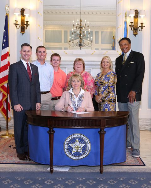 Gov. Mary Fallin held a ceremonial signing of SB 137 recently and was joined by the bill’s author, Sen. Corey Brooks (R-Washington), as well as Dillon, Dustin and Dana Stanley, Melanie Wilkins and Kermit R. McMurry, Ph.D. Vice Chancellor- Student Servi