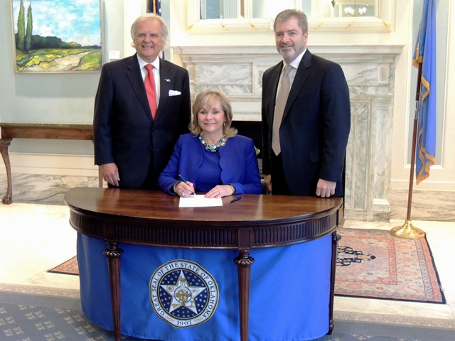 Rep. Richard Morrissette and Sen. Rob Standridge pose with Gov. Mary Fallin after the recent ceremonial signing of House Bill 1074.